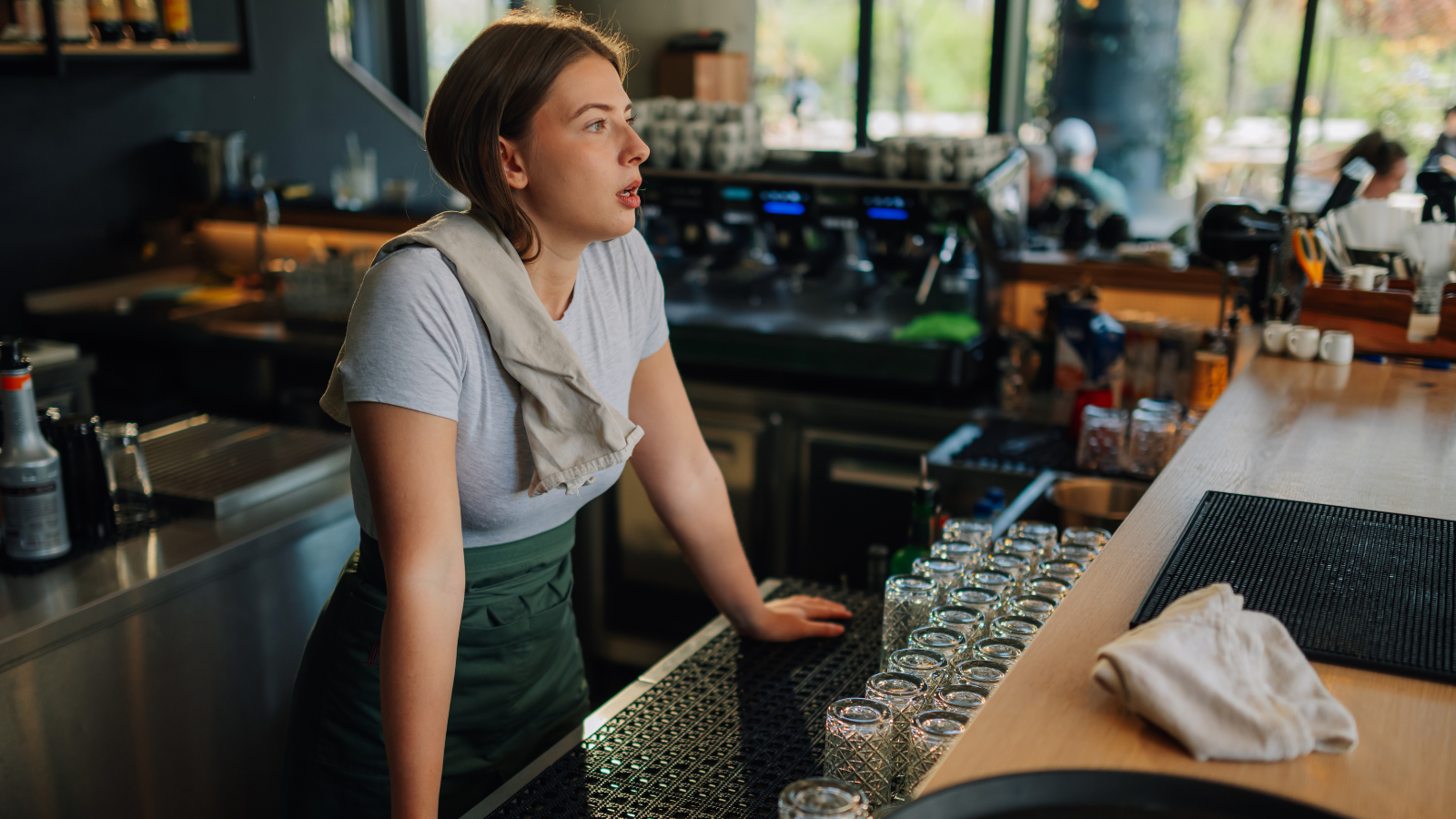 Woman serving behind a bar